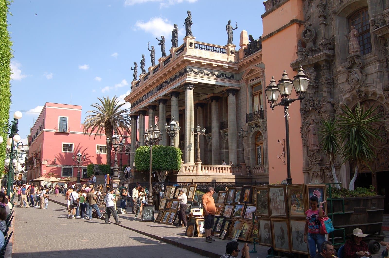 Teatro Juárez, with its columns and statues, and a street of painters